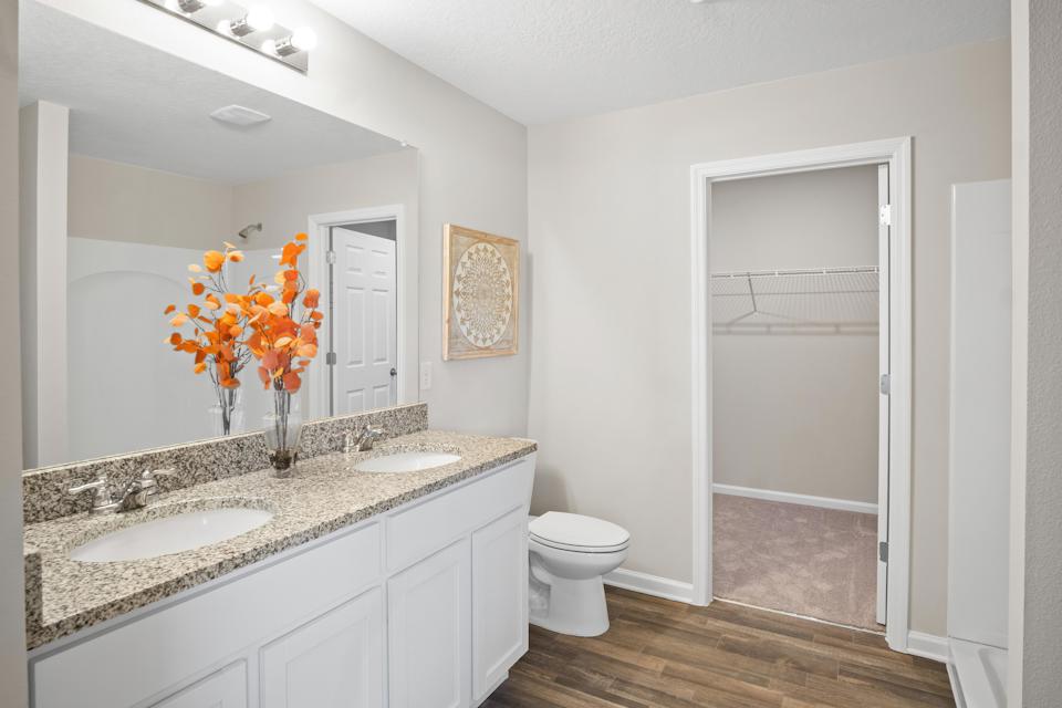 A bathroom with a sink toilet and a shower.