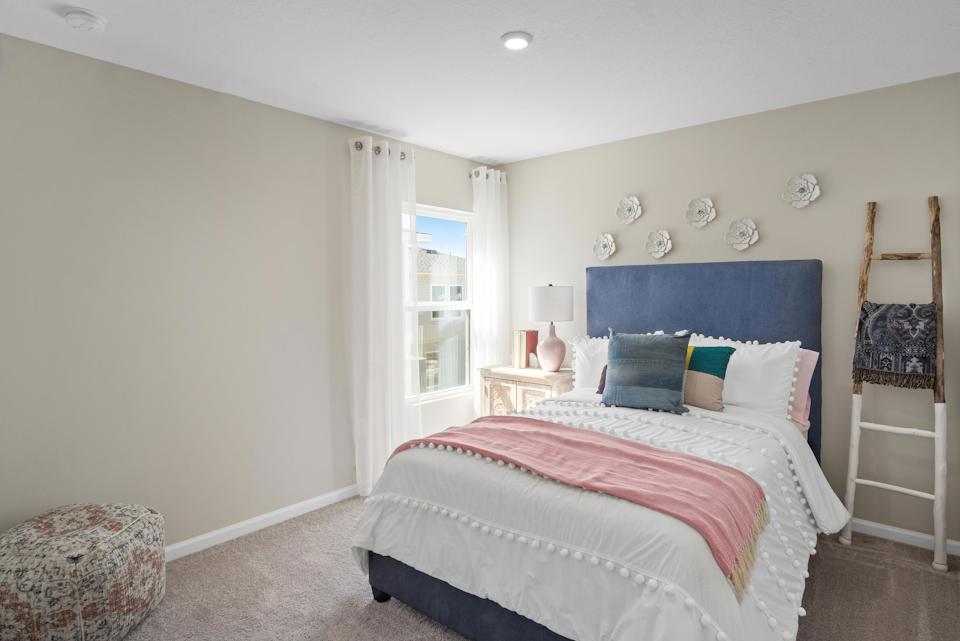 A bedroom with a bed and a window.