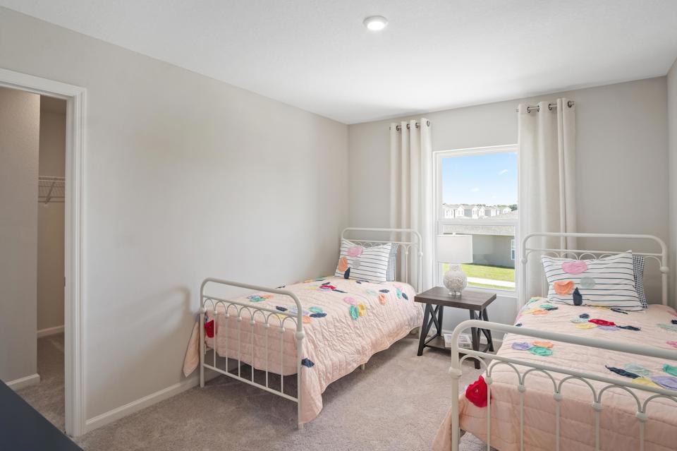 A bedroom with two beds.