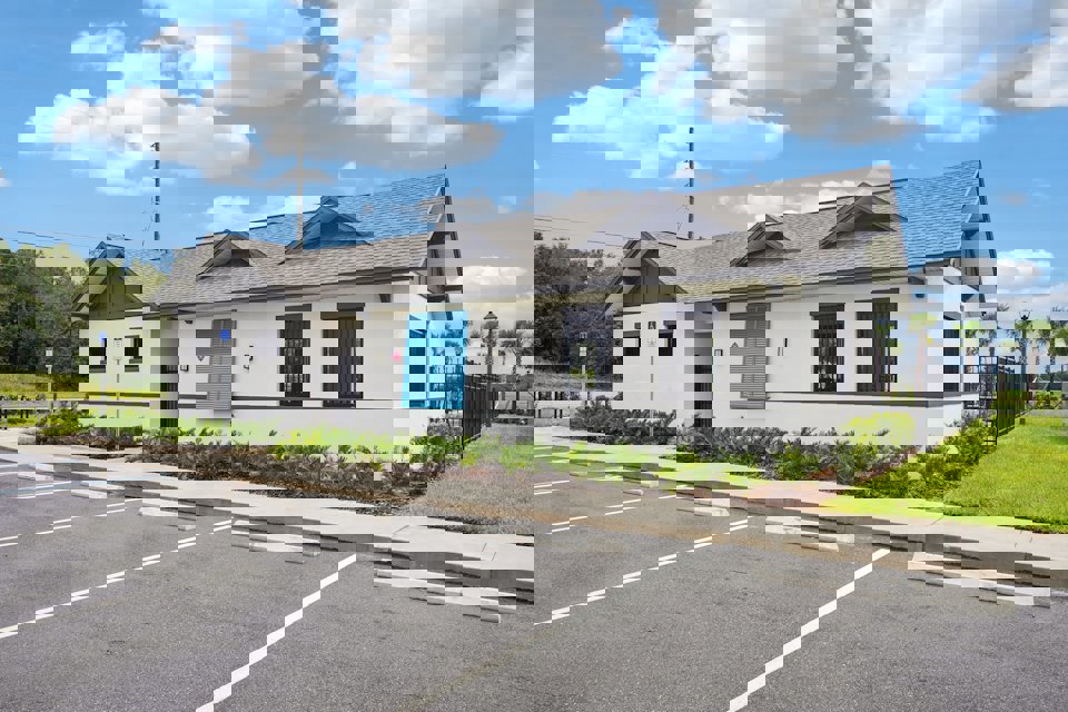 A white building with blue doors.