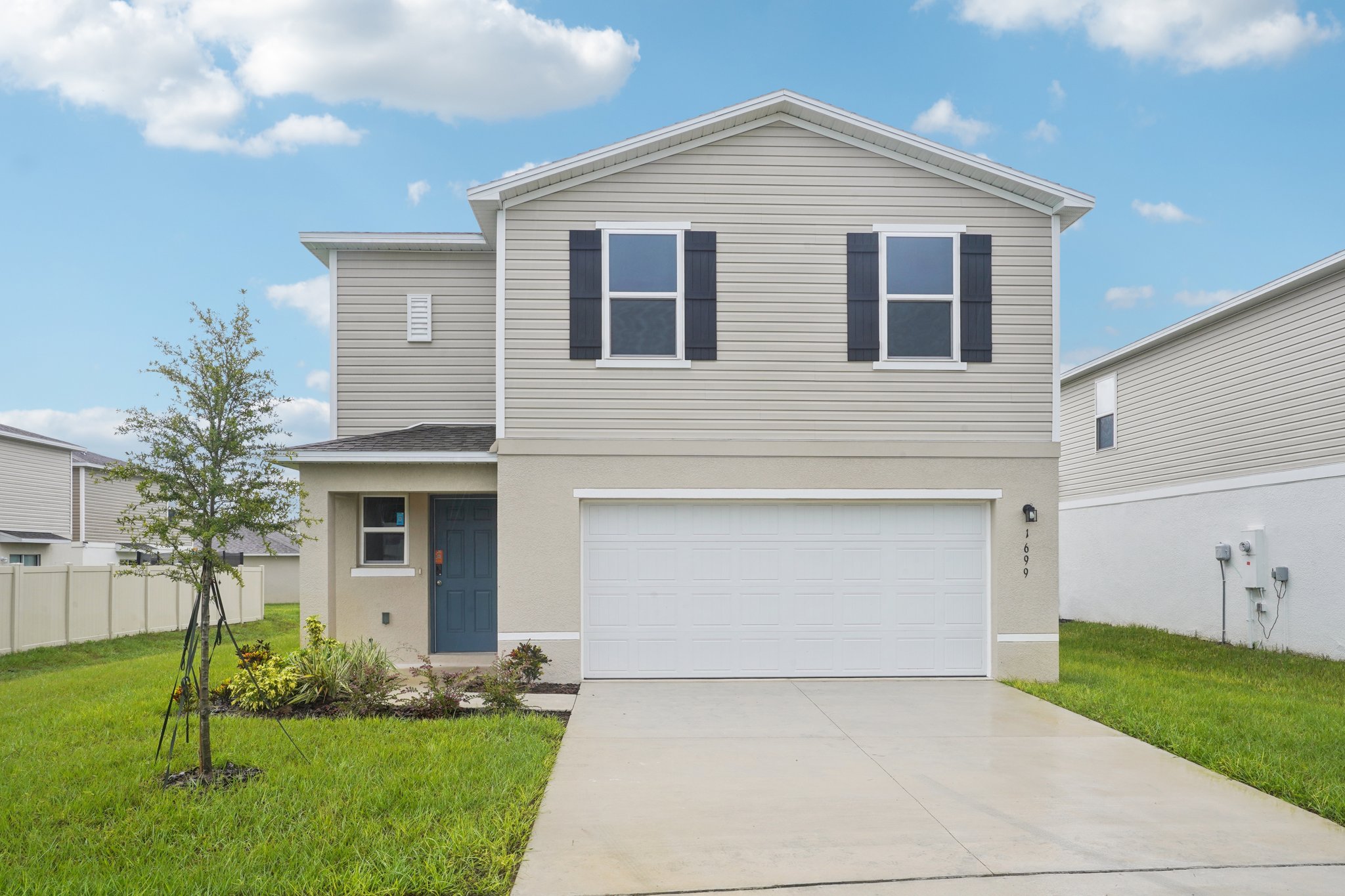 A white house with a garage.
