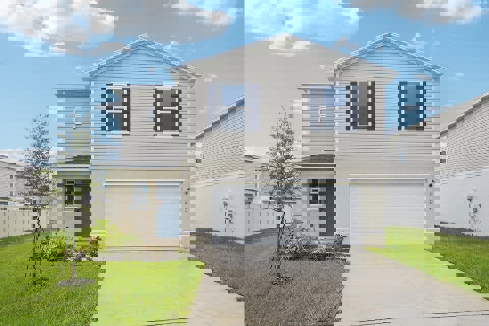 A white house with a garage.