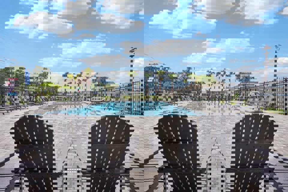 A pool with chairs around it.