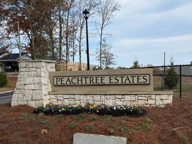 A sign on a stone wall.
