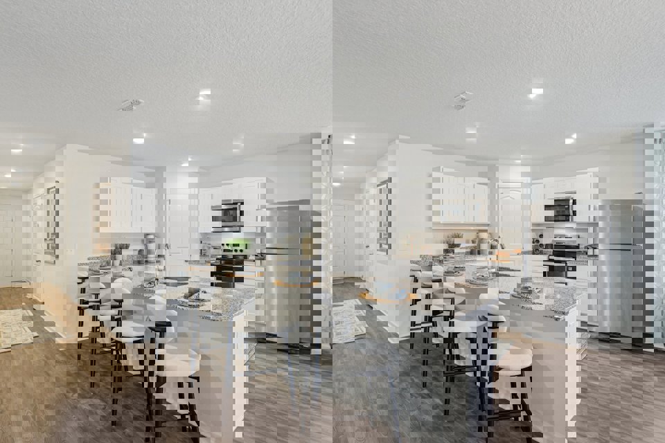 A kitchen with white cabinets.