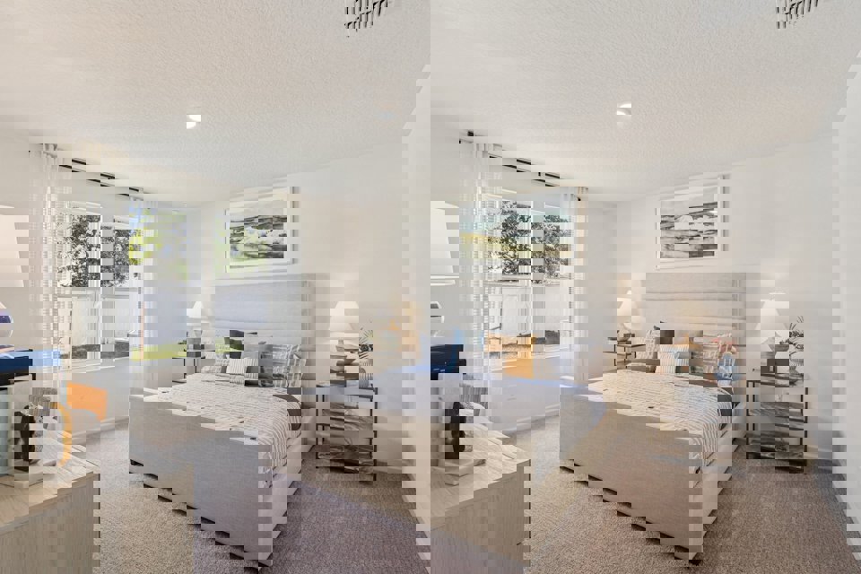 A bedroom with a bed and a desk.