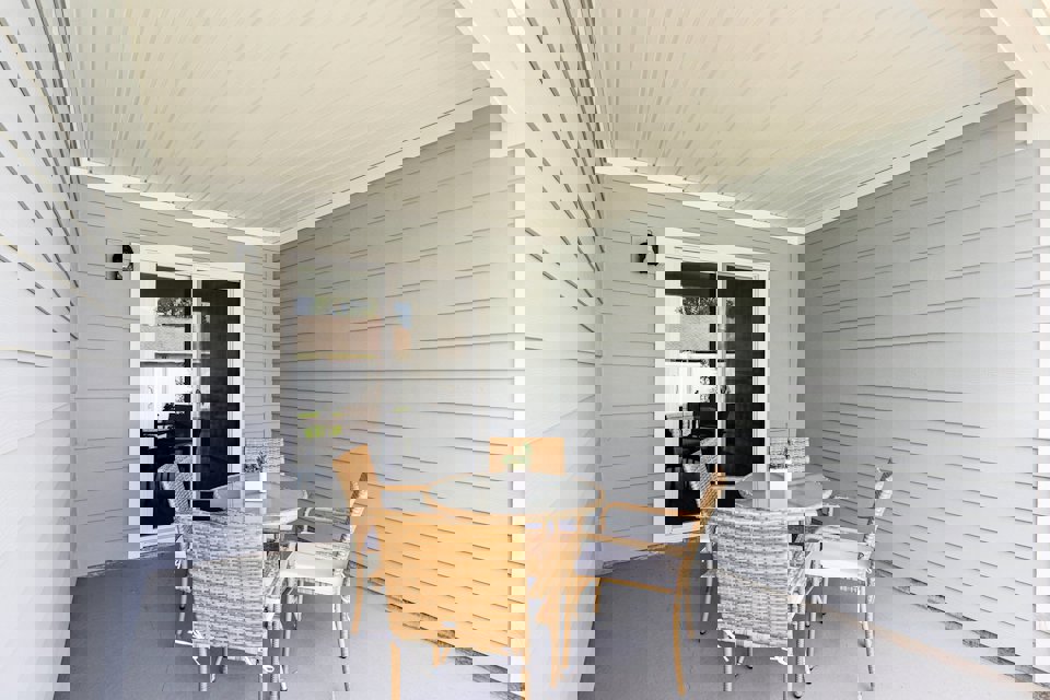 A dining room with a table and chairs.