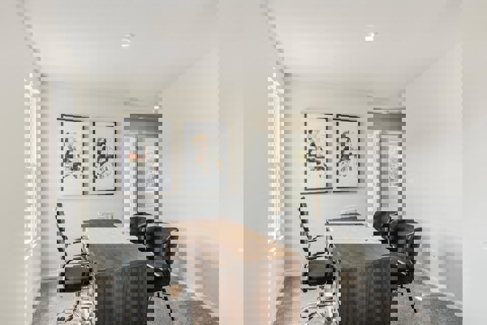 A room with a table and chairs.