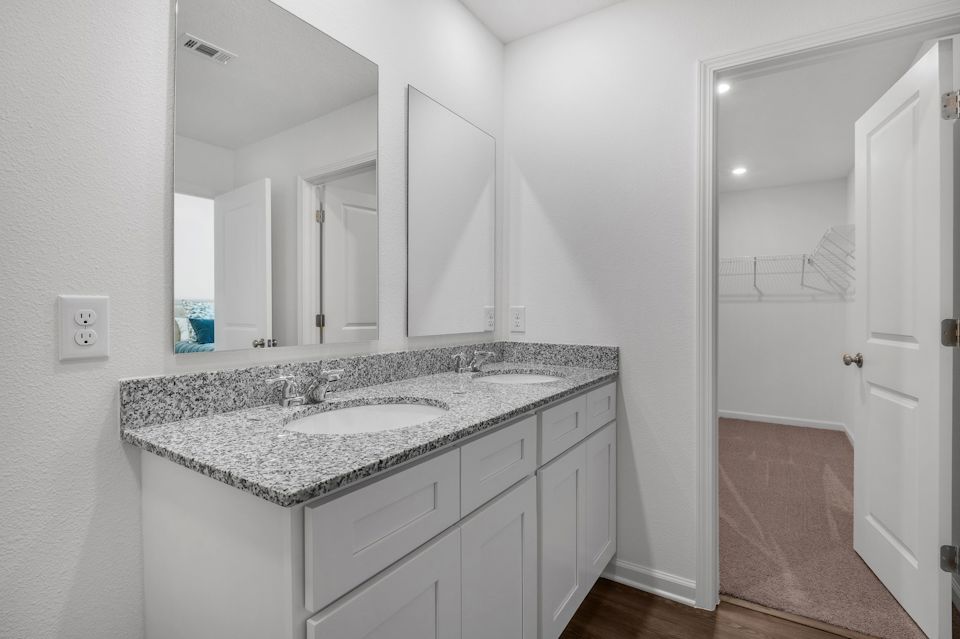 A bathroom with a marble countertop.