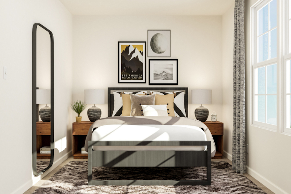 A bedroom with a bed and a mirror.