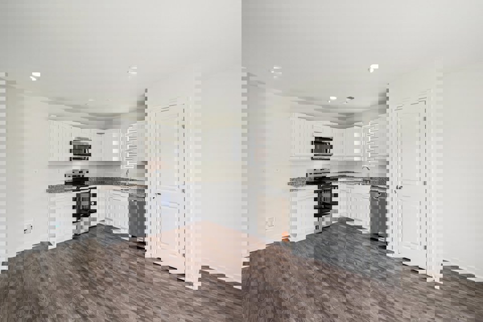 A kitchen with white cabinets.