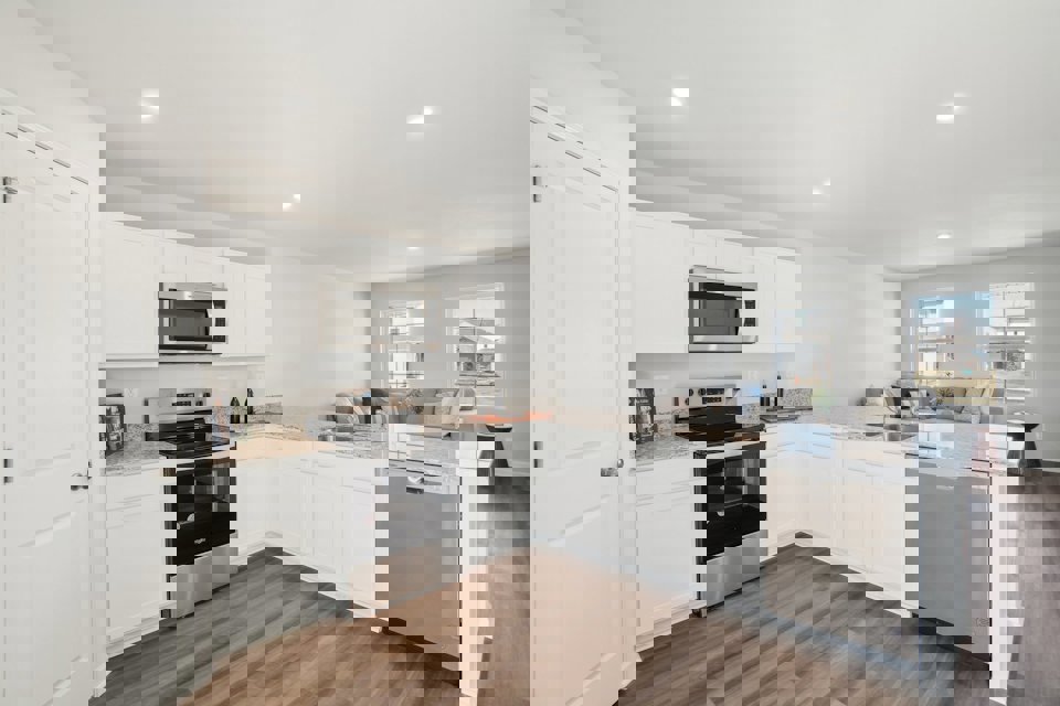 A kitchen with white cabinets.