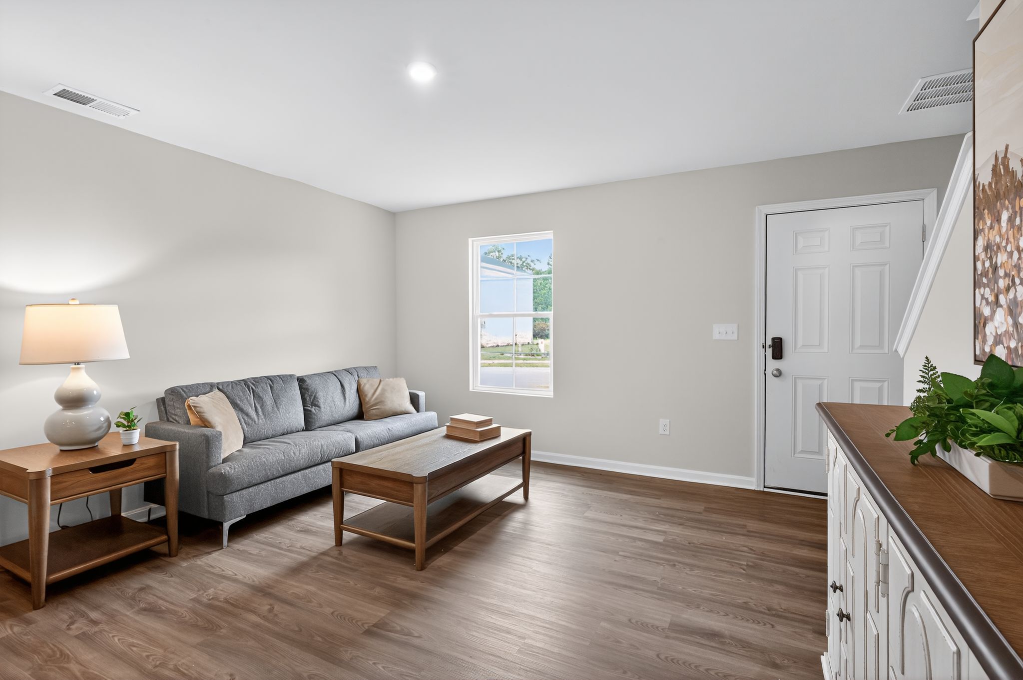 A living room with a wood floor.