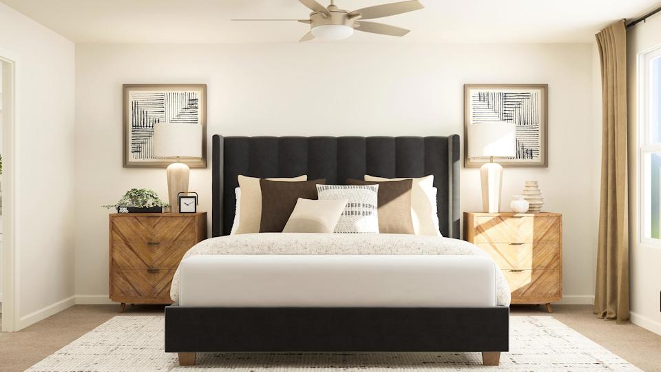 A bedroom with a bed and a fan.