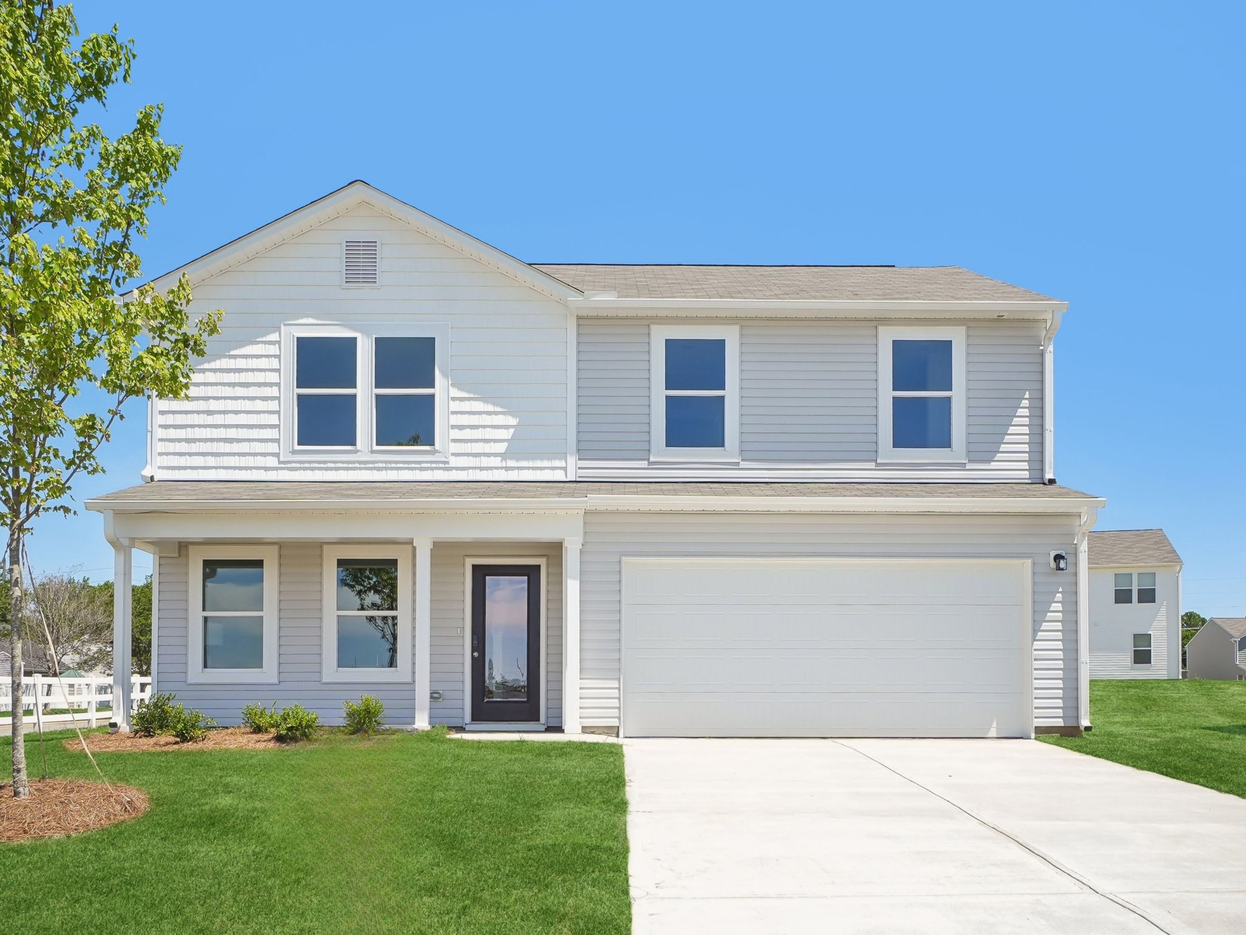 A white house with a garage.