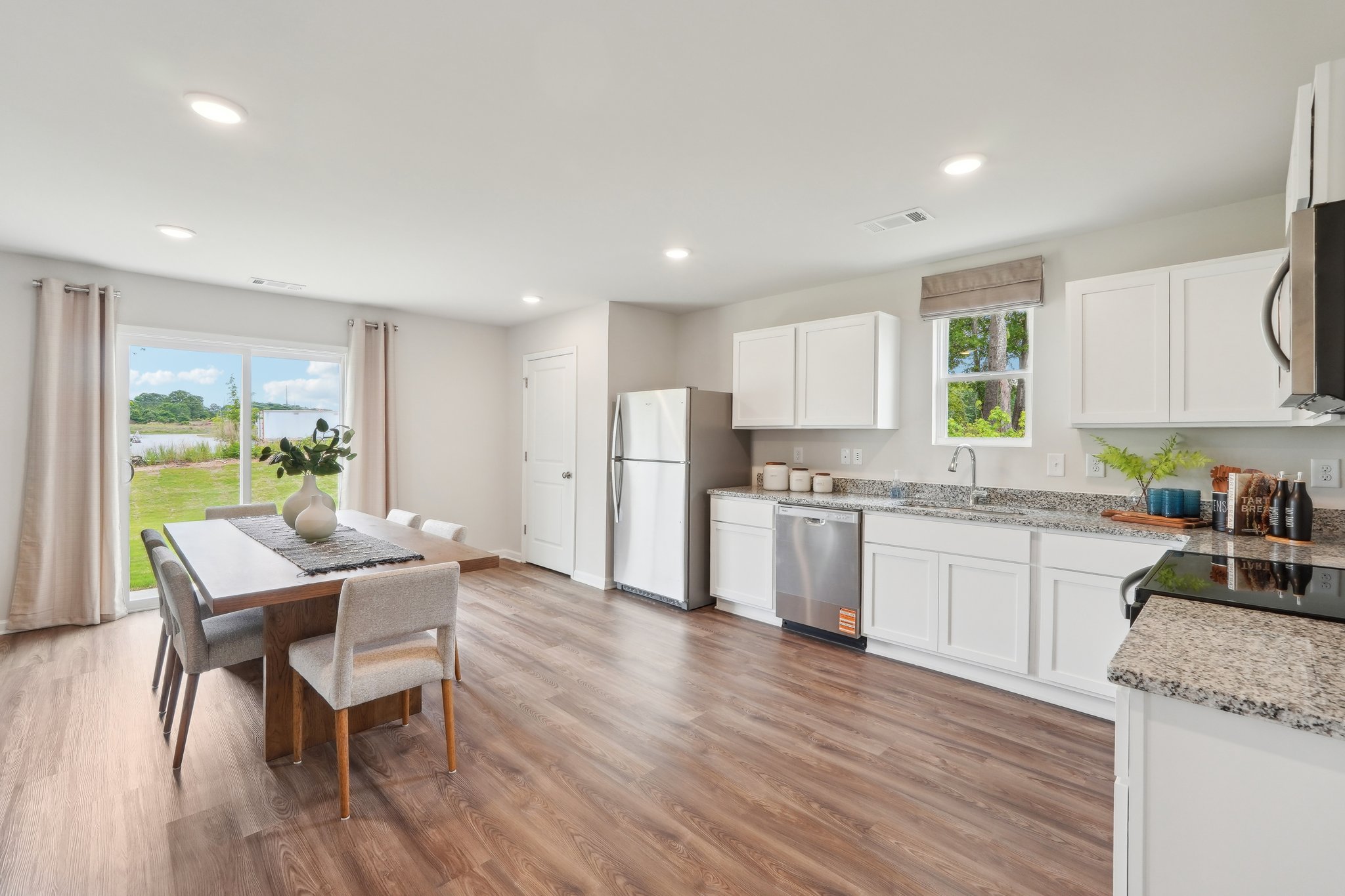 A kitchen with white cabinets.