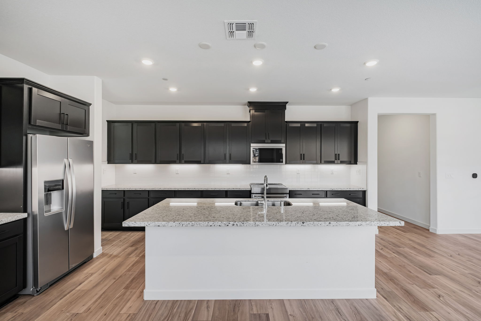 A kitchen with black cabinets.