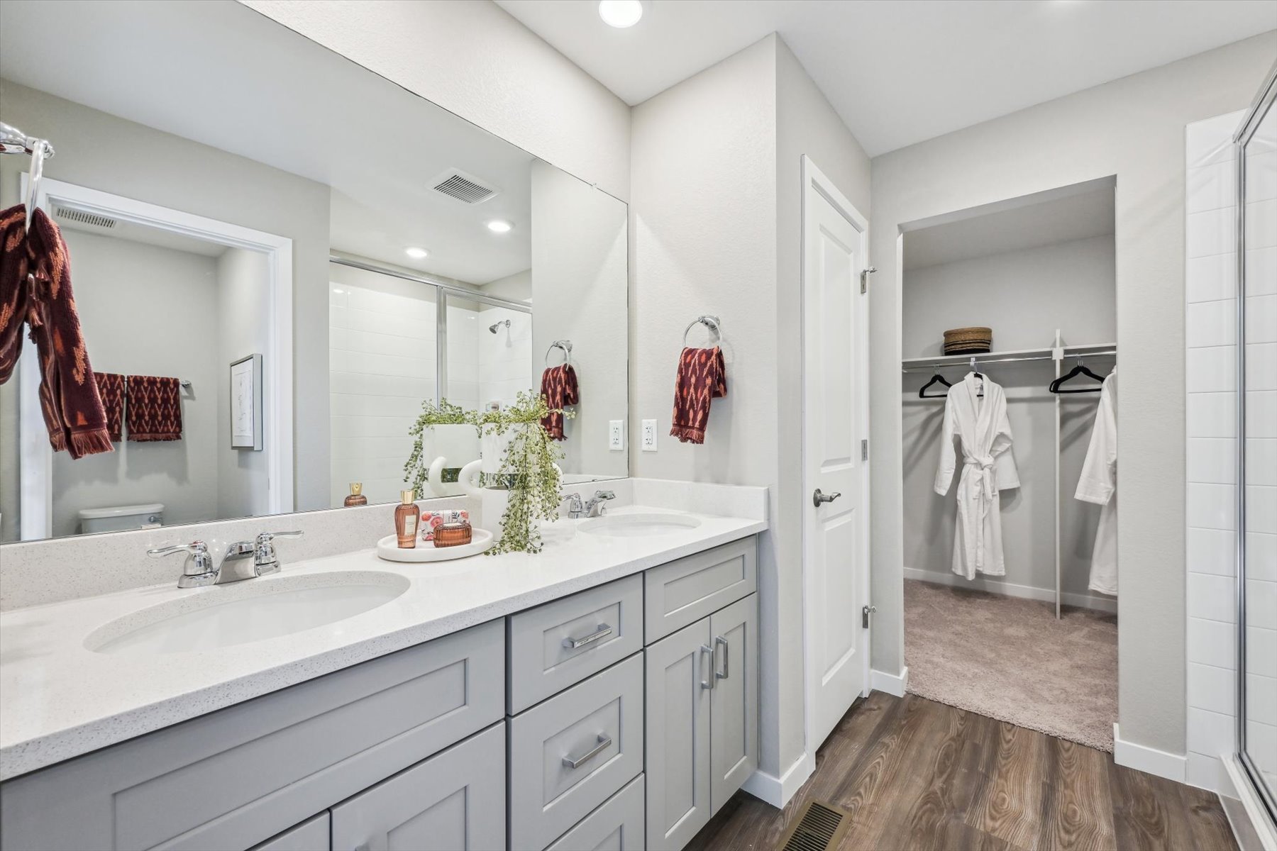 A bathroom with a large mirror.