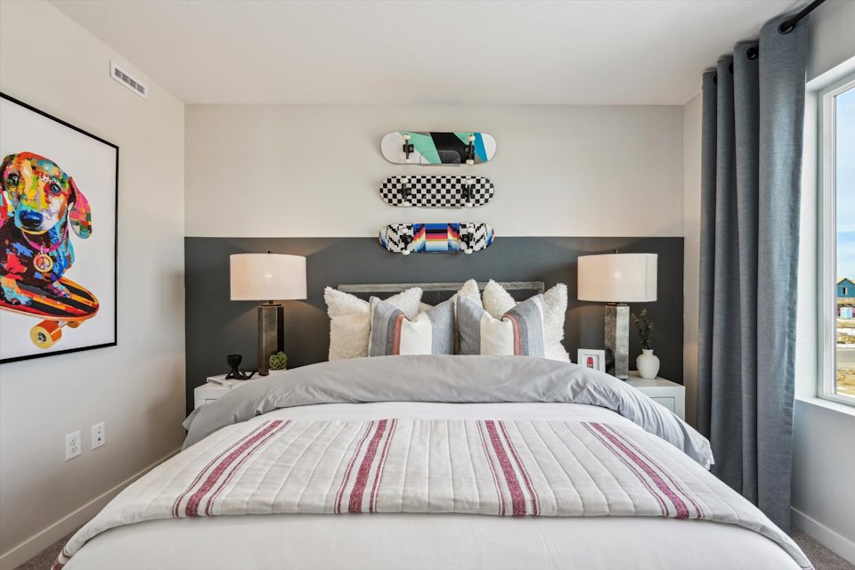 A bed with a striped blanket.